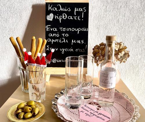 a table with a bottle of wine and a plate of food at Casa Delicosta- 2 Flat Country house with garden, 15 min from Trikala in Tríkala