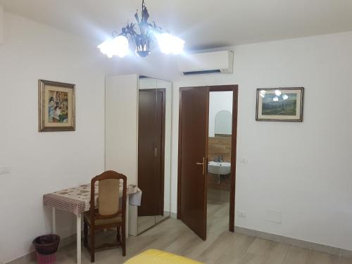 a bathroom with a table and a sink and a chandelier at Le Maschere in Mestre