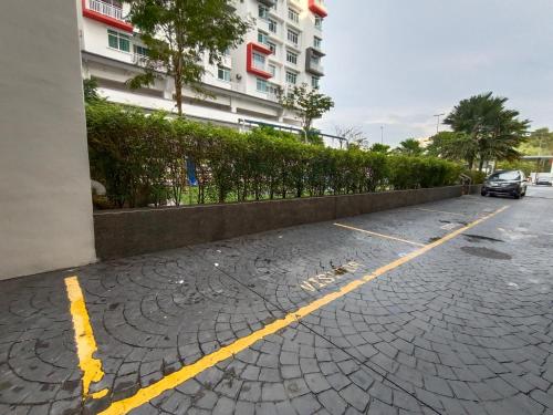 a car parked in a parking lot next to a building at KLIA Nilai Sepang EHSAN RESIDENCE 8 PAX Air-Con Homestay in Sepang
