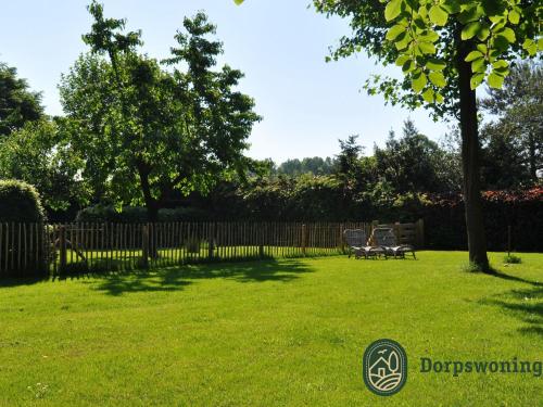 a yard with a fence and a table and chairs at Cottage in Leenderbos near Nature Reserve in Leende