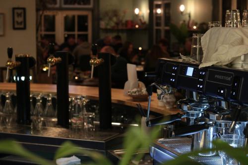 a bar with a counter with glasses on it at Hotel De Gravin van Vorden in Vorden