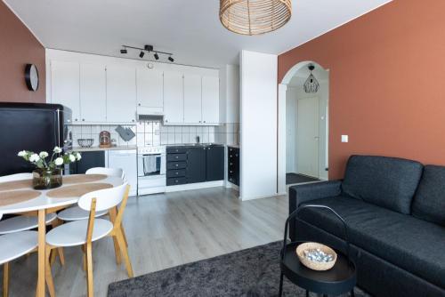 a living room with a couch and a table at Arctic Night City Suite in Rovaniemi