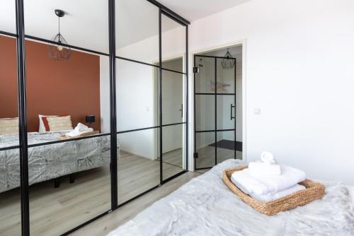 a bedroom with sliding glass doors and a bed with white sheets at Arctic Night City Suite in Rovaniemi