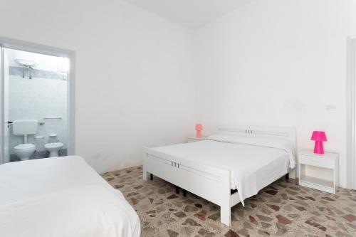 Postel nebo postele na pokoji v ubytování Appartamento fronte mare e spiaggia