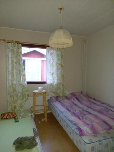 a bedroom with a bed and a window at Talo mäellä in Juuka