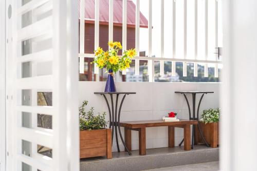 a room with two tables and a vase of flowers at Casa Villa - Dalat Valley View in Da Lat