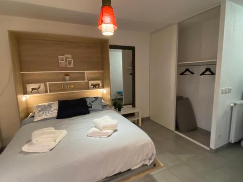 sypialnia z dużym łóżkiem z dwoma ręcznikami w obiekcie Studio Chic Little Bohême 40 mn du stade olympique w mieście Lyon