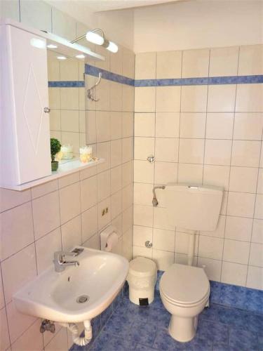 a bathroom with a toilet and a sink at Apartmenthotel Sithon in Sarti