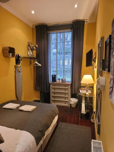 a bedroom with a bed and a window at The Residence - NO 8 in Edinburgh