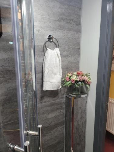 a shower with a white bag hanging on a wall at The Residence - NO 8 in Edinburgh