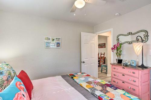 a bedroom with a bed and a pink dresser at Walk to Cedar Creek Reservoir Home with Fire Pit! in Tool