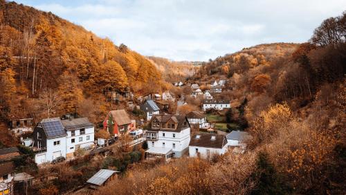 a small town in the mountains with autumn trees at Love Cottage mit Whirlpool in Hagen