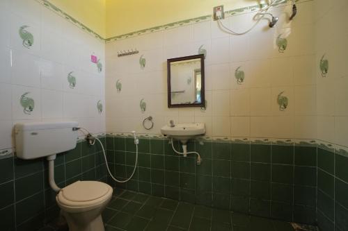 a bathroom with a toilet and a sink at Karthik residence in Puducherry