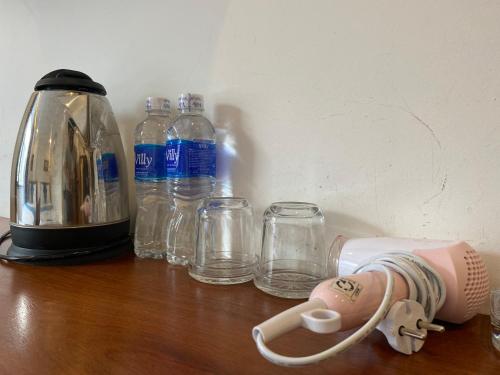 a counter with glasses and a toaster and bottles of water at Hotel Hoàng Hưng Quy Nhơn in Quy Nhon
