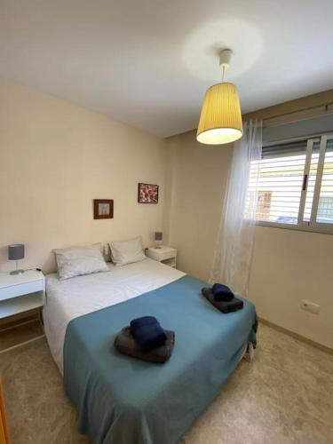 een slaapkamer met een bed met twee handdoeken erop bij 2 Bedrooms and sofa bed flat by Wayra Tarifa in Tarifa