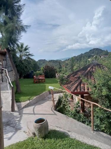 a view of a house with a patio and a yard at Kivu Macheo eco-lodge in Kibuye