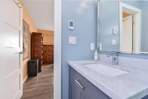 a bathroom with a sink and a mirror at Bazan Bay Beach House in North Saanich