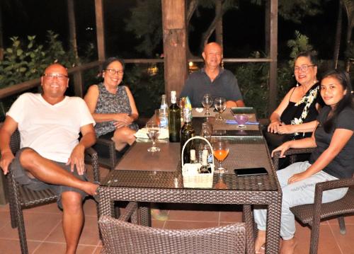 a group of people sitting at a table at Island View Beachfront Resort in Anda