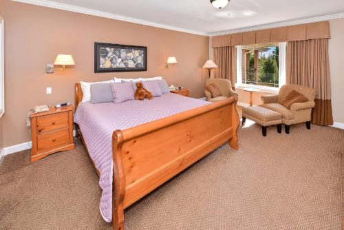 a bedroom with a large bed with a dog laying on it at Miraloma 209 in Sidney