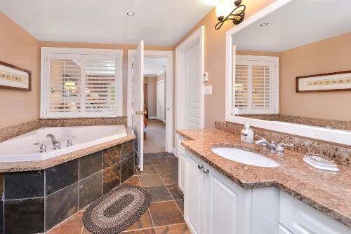 a bathroom with two sinks and a large mirror at Miraloma 209 in Sidney