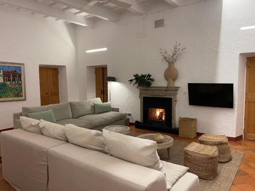 a living room with a couch and a fireplace at Agroturismo Bini Aumaia in Es Mercadal
