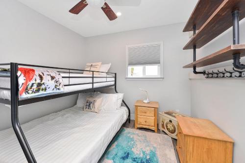 a bedroom with a bunk bed and a desk at Dragonfly Cottage in Nanaimo