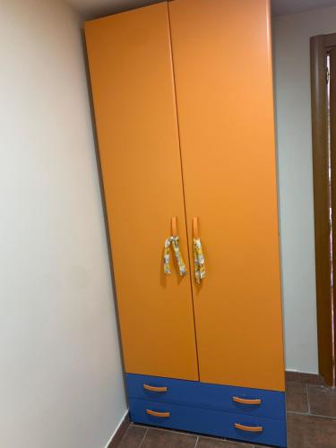 a orange cabinet with two bow ties on it at La pagliara in Ercolano