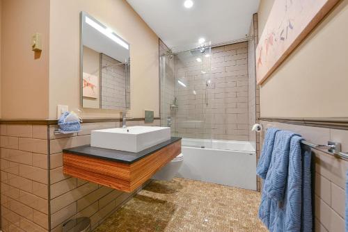 a bathroom with a sink and a toilet and a tub at Salishan Chief Suite in Cowichan Bay