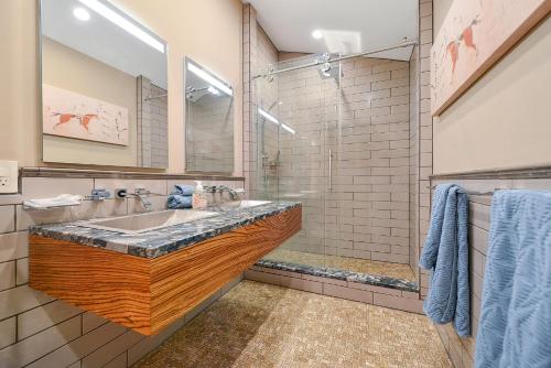 a bathroom with a sink and a shower at Salishan Tree House Suite in Cowichan Bay