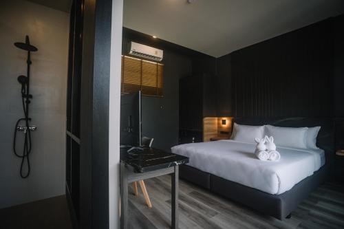 a bedroom with a bed with two stuffed animals on it at INN BLOG HOTEL Pakbara in Satun