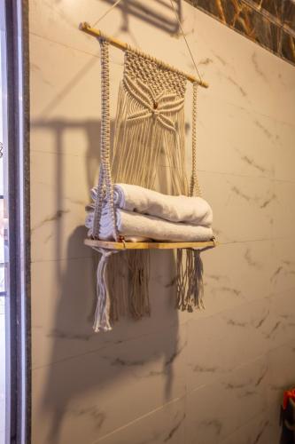 a hanging shelf with towels on a wall at VILLA ZORBA - 4BHK Villa in Candolim in Old Goa