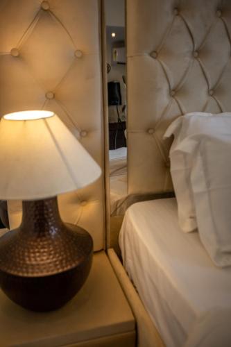 a lamp sitting on a table next to a bed at VILLA ZORBA - 4BHK Villa in Candolim in Old Goa