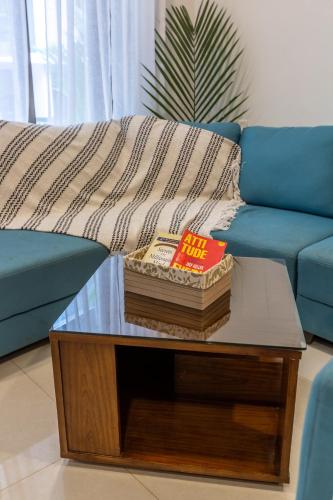 a living room with a couch and a coffee table at VILLA ZORBA - 4BHK Villa in Candolim in Old Goa