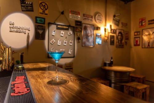 a bar with a blue glass sitting on a counter at 框框背包客棧 Kuang Kuang Hostel in Longjing