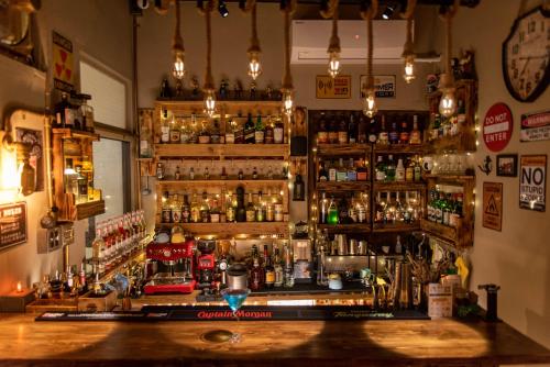 a bar with a lot of bottles on the wall at 框框背包客棧 Kuang Kuang Hostel in Longjing