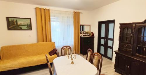 a dining room with a table and a chair and a room with a window at Agroturystyka u Pruszyńskich in Mońki