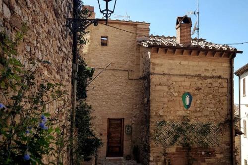 an old brick building next to a building at *La Torre Di Amelia* Nel Cuore Dell' Umbria in Amelia