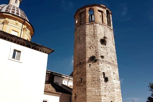 a tall brick tower next to a building at *La Torre Di Amelia* Nel Cuore Dell' Umbria in Amelia