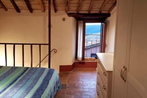 a bedroom with a bed and a window at *La Torre Di Amelia* Nel Cuore Dell' Umbria in Amelia