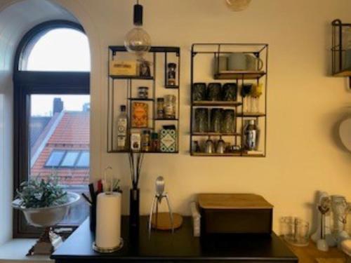 a kitchen with a counter with a window and a counter top at Kongens Apartment St Joseph in Kristiansand