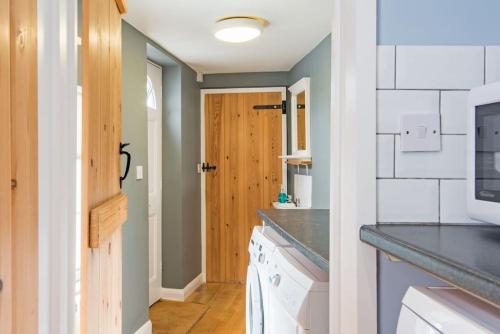 a kitchen with a sink and a counter top at Curious Cottage in Deal