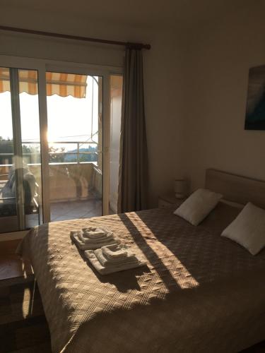 a bedroom with a bed with two towels on it at Swimming Apartment in Rijeka