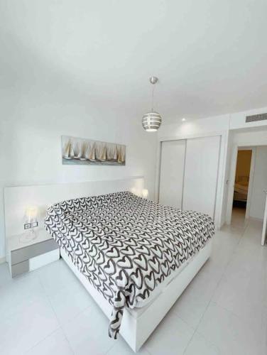 a white bedroom with a large bed in it at NEW GROUNDFLOOR APT. ARENALES DEL SOL in Arenales del Sol