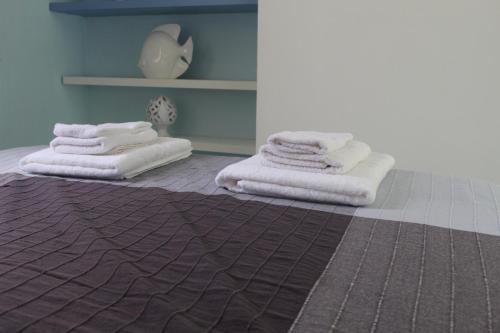 two stacks of towels sitting on the floor in a room at Casa Azzurra in Cetara