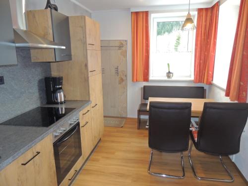 a kitchen with a table and chairs and a dining room at Villa Anna in Bad Gastein