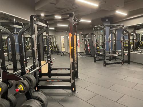 a gym with rows of dumbbells in a room at Comfort Hotel Linköping City in Linköping