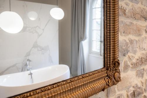 a bathroom with a mirror and a sink at Couvent de la Salette & Spa in Millau