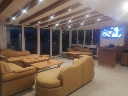 a living room with couches and a flat screen tv at Urban Boutique Hotel Pokhara in Pokhara