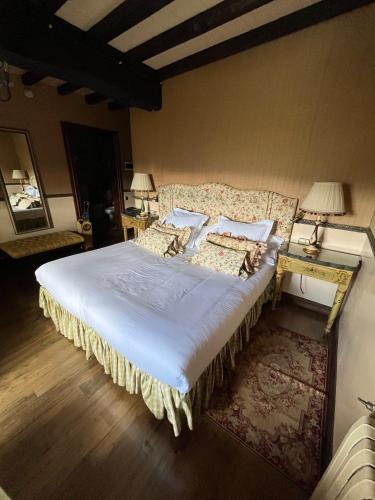 a bedroom with a large bed and a table with lamps at Palacio de Cutre in La Goleta