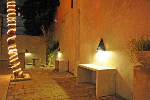a couple of benches on a sidewalk at night at The Villa In Lavinia in Mount Lavinia